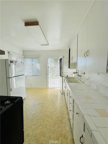 a large bathroom with a granite countertop double vanity and a large mirror