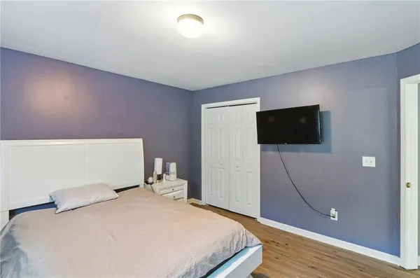 a bedroom with a bed and a flat screen tv
