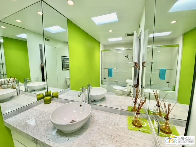 a bedroom with a large bed and a large window