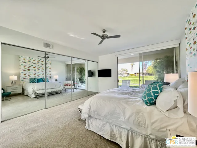 a patio with a table and chairs under an umbrella