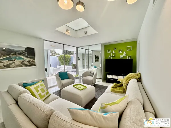 a living room with furniture and a flat screen tv