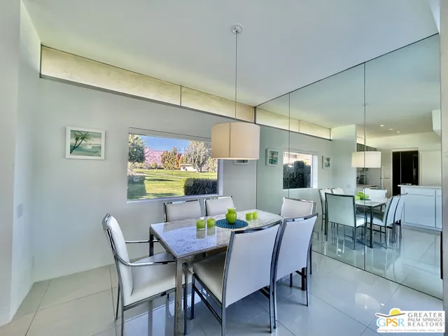 a bedroom with a bed mirror and couch