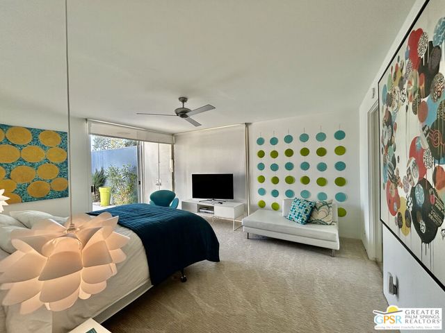 a bedroom with furniture and a window