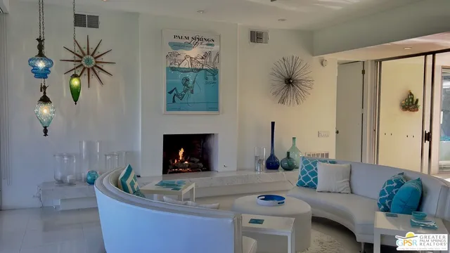 a living room with a rug and a wooden floor