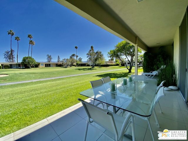 a view of a backyard with a table and chairs