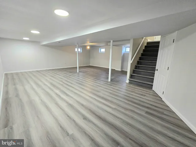 a view of a room with wooden floor