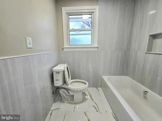 a bathroom with a toilet a sink and a bathtub