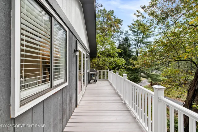 a view of a balcony with wooden floor