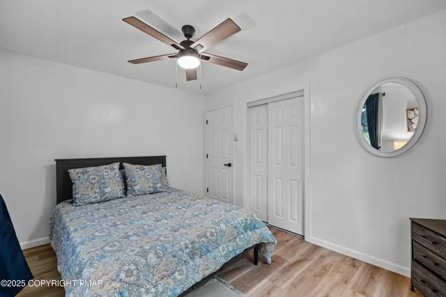 a bedroom with a large bed and a chandelier