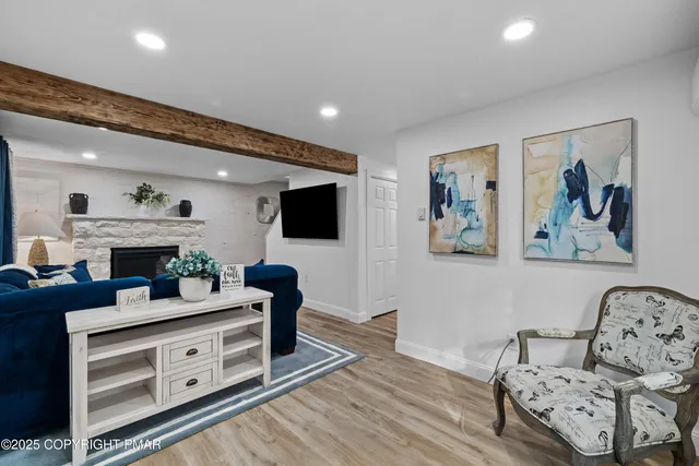 a living room with furniture and a fireplace