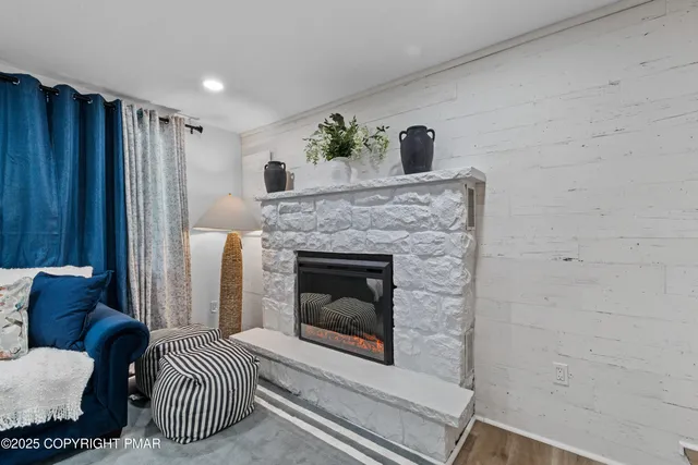 a living room with furniture and a fireplace