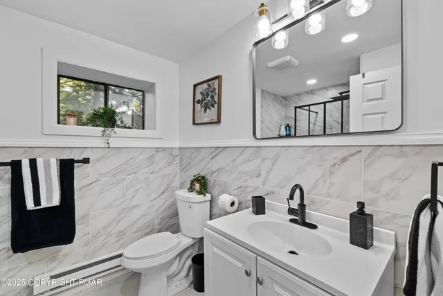 a bathroom with a sink toilet and mirror