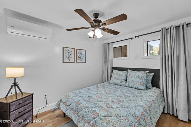 a bedroom with a bed and a lamp on a dresser