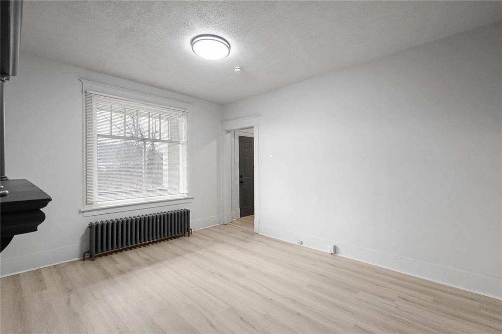 306 Park Road Ambridge, PA 15003 - Photo 2 of 43 an empty room with wooden floor and windows
