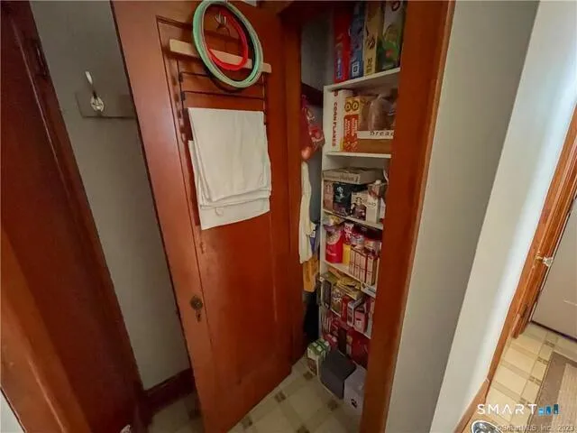 a bedroom with a bed a couch and dresser