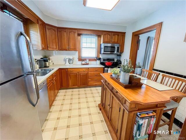 16 Meriden Avenue Meriden, CT 06451 - Photo 10 of 29 a kitchen with stainless steel appliances granite countertop a sink a stove a refrigerator a counter top space and cabinets