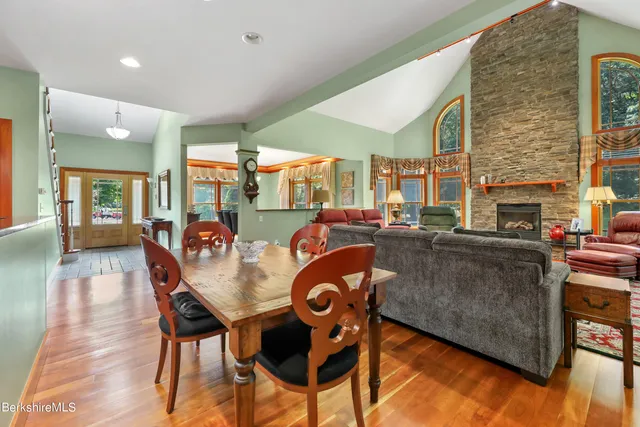 a kitchen with stainless steel appliances granite countertop a stove and a wooden floors