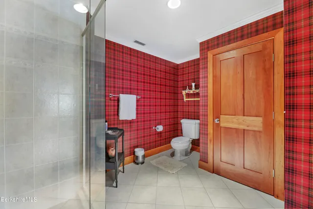 a bathroom with a granite countertop sink mirror and shower