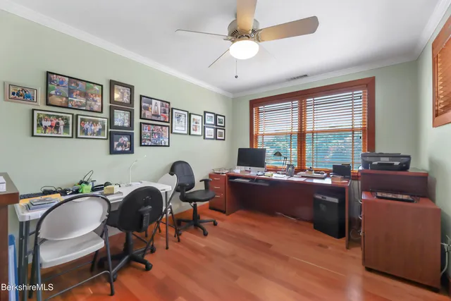a bedroom with a bed and closet with mirror