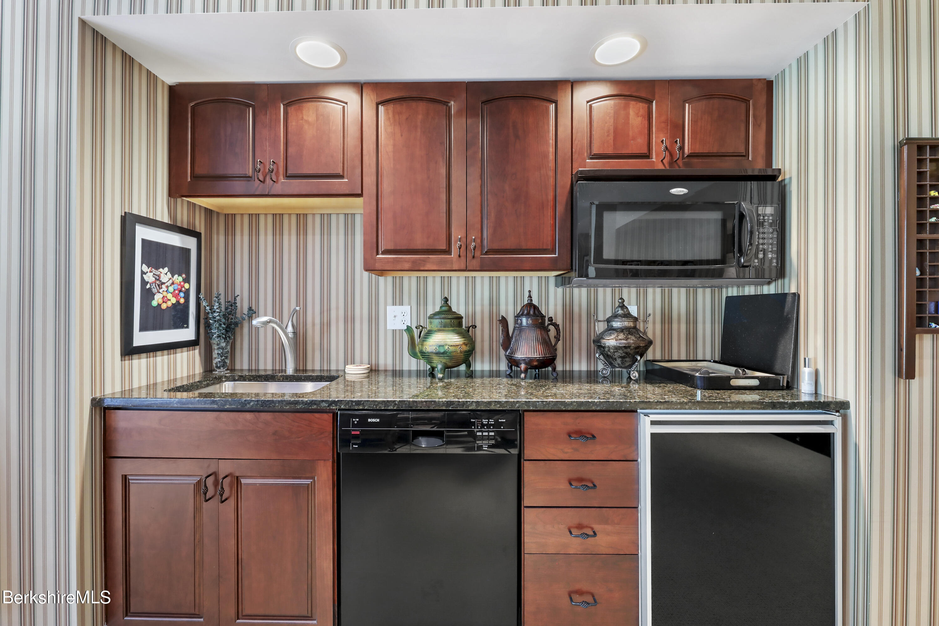 82 Stockbridge Terrace, Unit 82 Lee, MA 01238 - Photo 40 of 64 a kitchen with stainless steel appliances granite countertop a stove a sink and a microwave