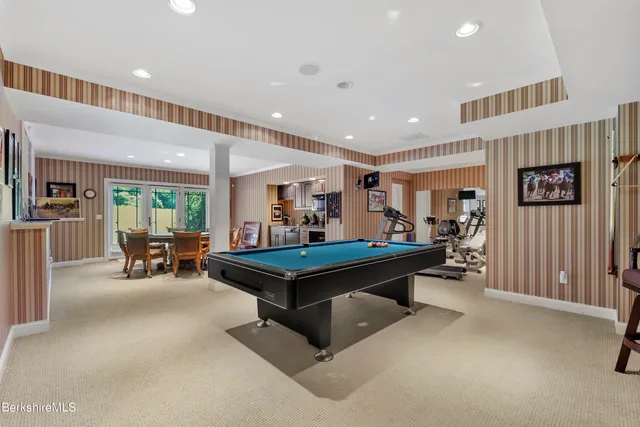 an aerial view of green landscape with trees houses and mountain view