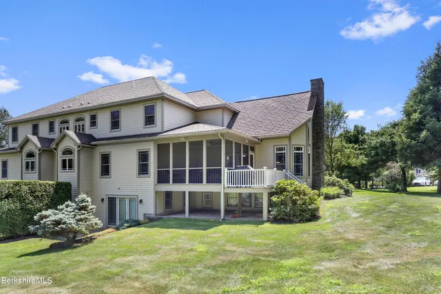 a aerial view of a house with a yard and potted plants