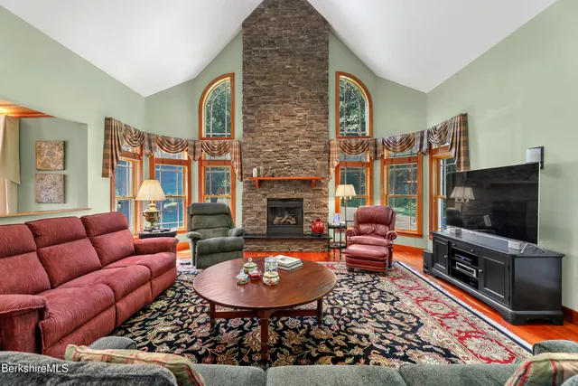 a living room with furniture flat screen tv and a fireplace
