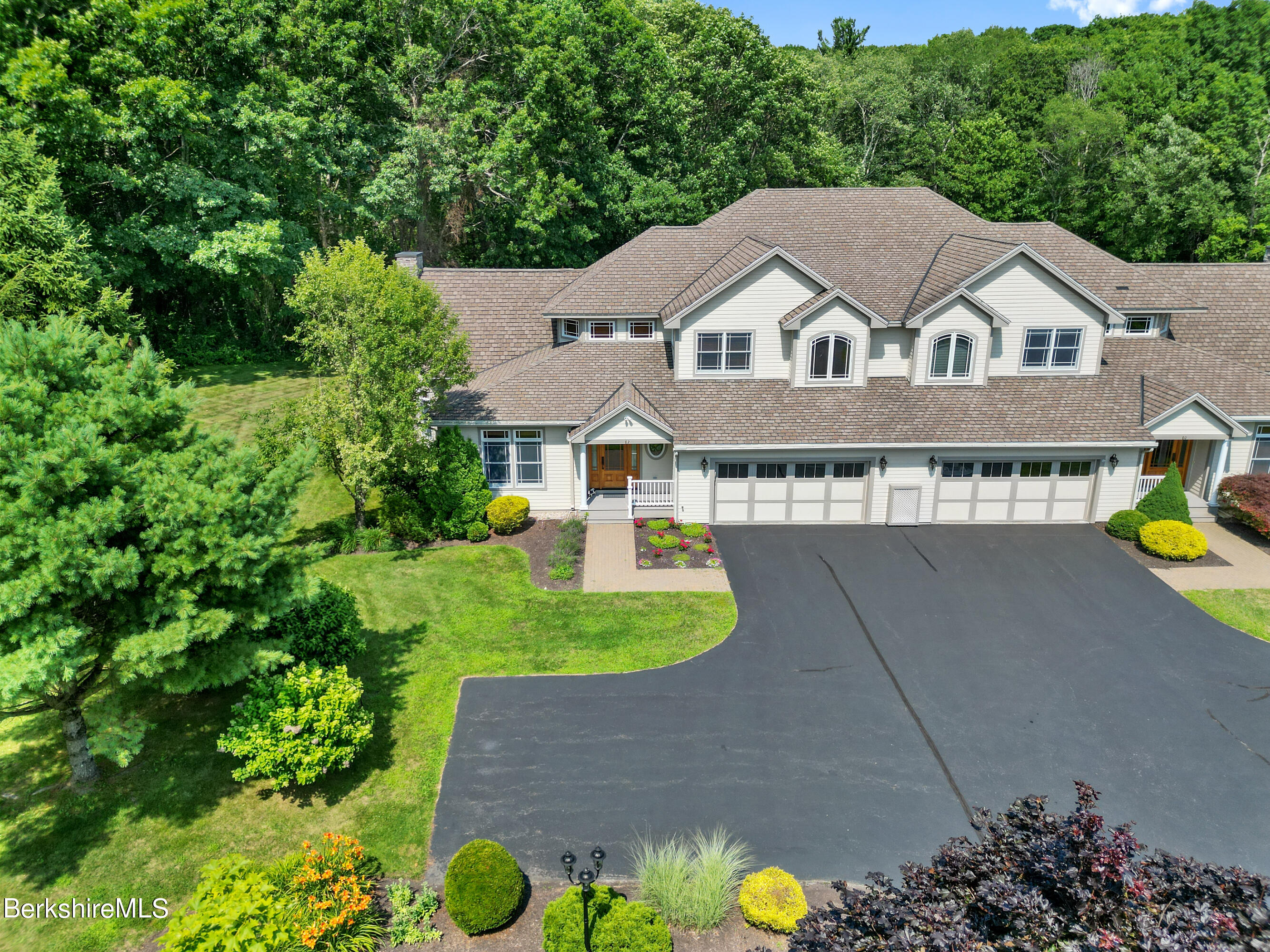 82 Stockbridge Terrace, Unit 82 Lee, MA 01238 - Photo 51 of 64 a aerial view of a house with a yard and potted plants