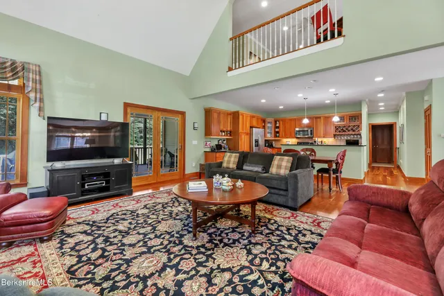 a living room with furniture a flat screen tv and a dining table