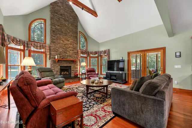 a living room with furniture a fireplace and a large window