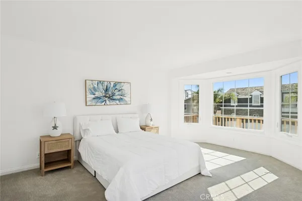 a bedroom with a large bed and a large window