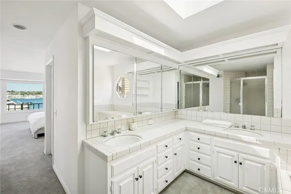 a bathroom with a granite countertop sink mirror bathtub and shower