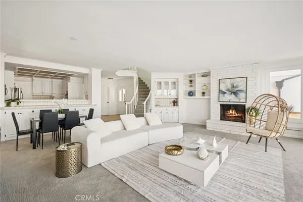 a living room with furniture a rug and a window