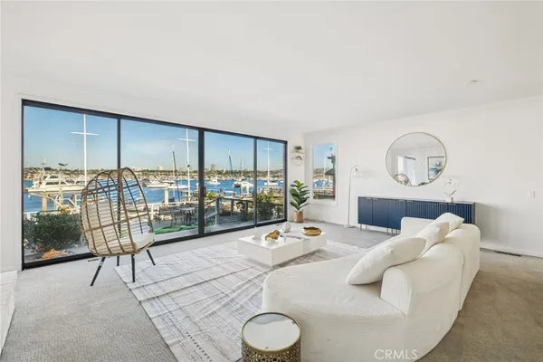 a living room with furniture large window and a flat screen tv
