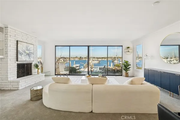 a living room with furniture and a floor to ceiling window