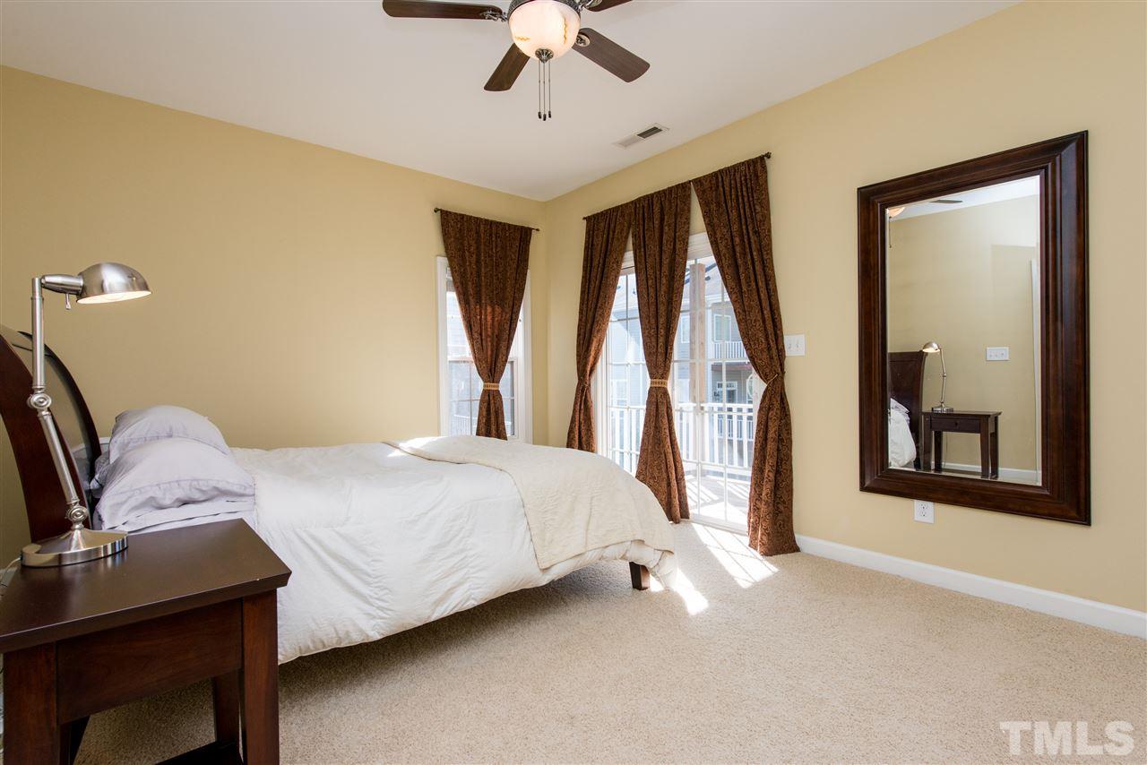 3517 Edgemont Drive Raleigh, NC 27612 - Photo 16 of 25 a bedroom with a bed next to a window with a bookshelf