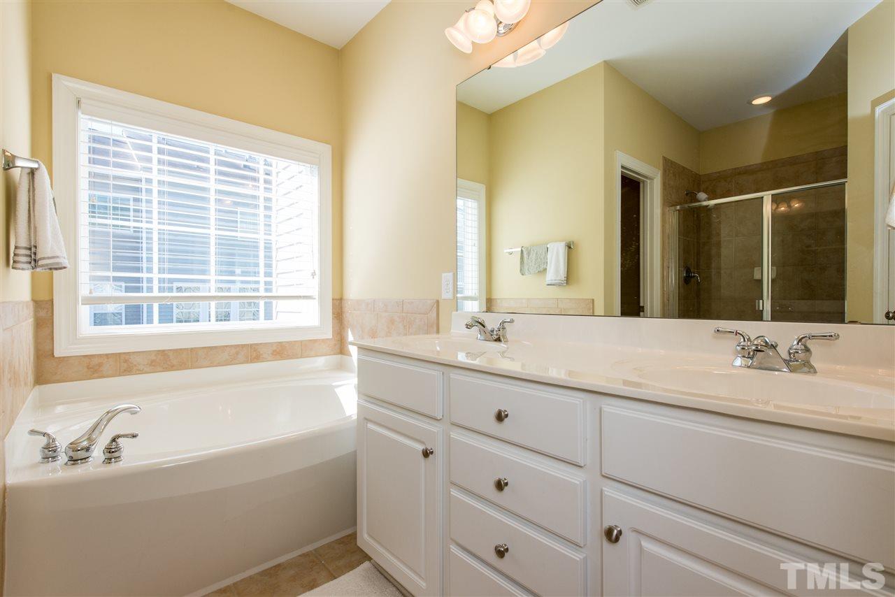 3517 Edgemont Drive Raleigh, NC 27612 - Photo 17 of 25 a bathroom with a tub sink and mirror