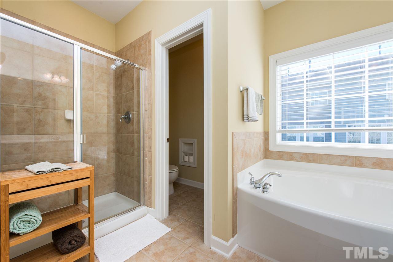 3517 Edgemont Drive Raleigh, NC 27612 - Photo 18 of 25 a bathroom with a bathtub and a shower