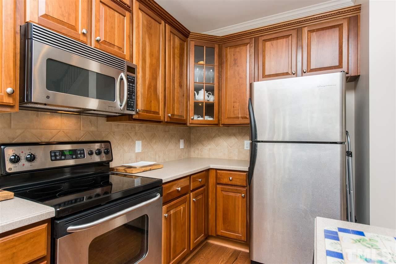 3517 Edgemont Drive Raleigh, NC 27612 - Photo 10 of 25 a kitchen with a stove microwave and refrigerator
