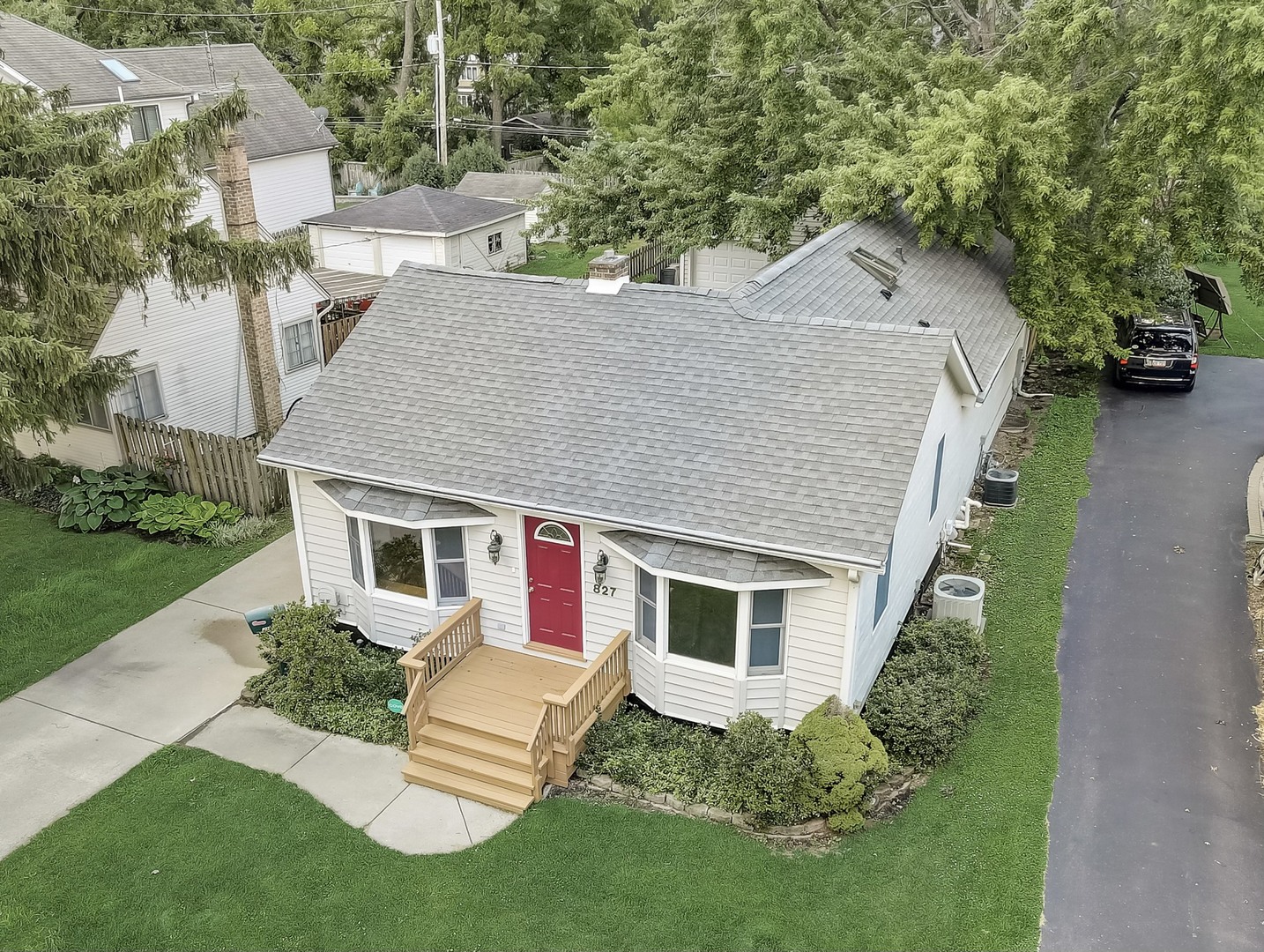 a aerial view of a house with a yard table and chairs