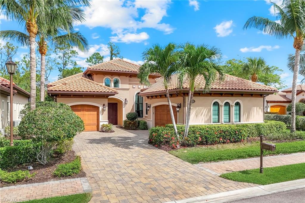 Mediterranean / spanish-style home featuring stucco siding, an attached garage, a tile roof, and decorative driveway