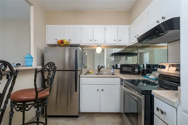 a kitchen with a sink appliances and cabinets