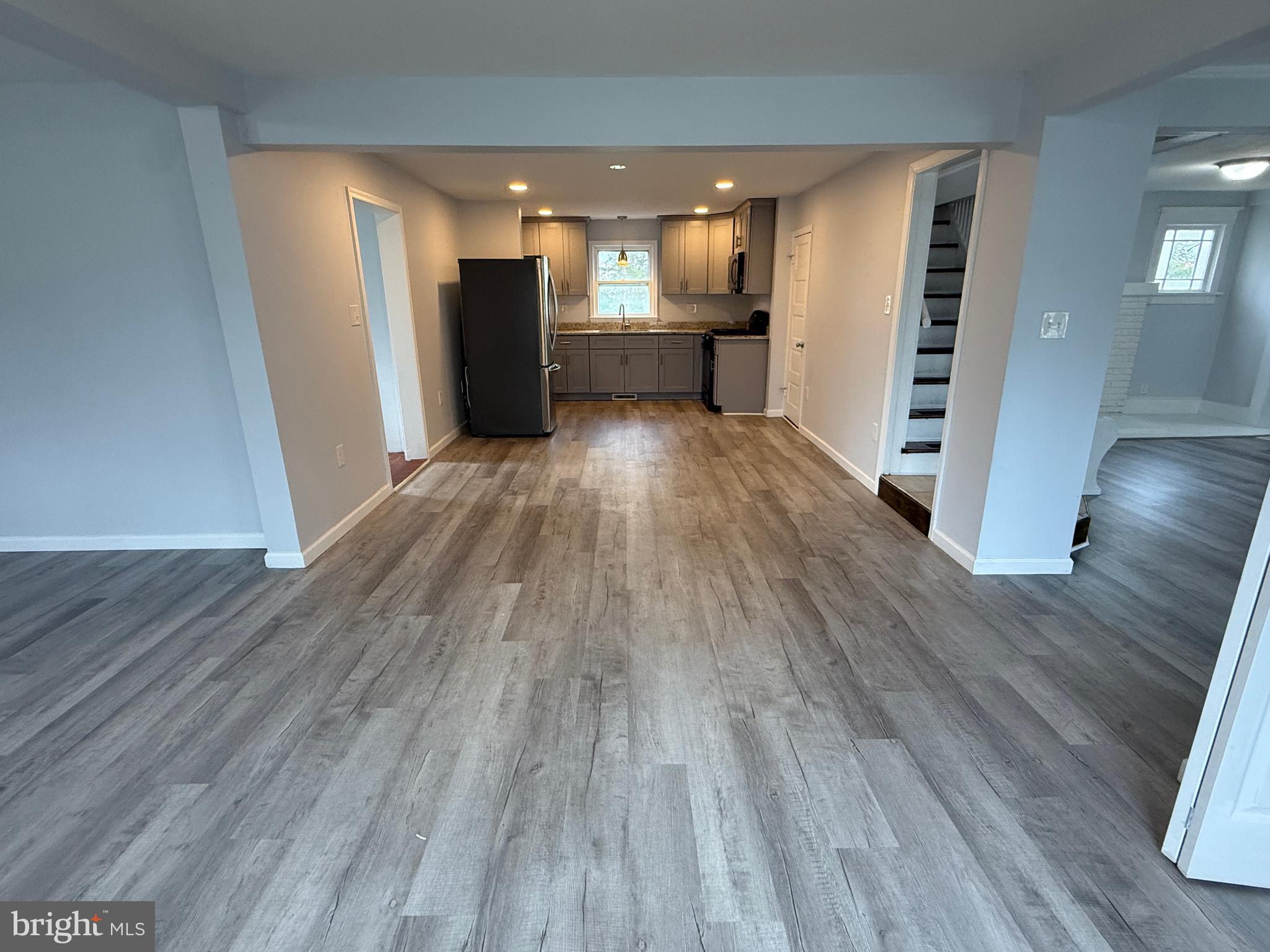 1036 South Spring Road Vineland, NJ 08361 - Photo 14 of 31 wooden floor in an empty room with a kitchen