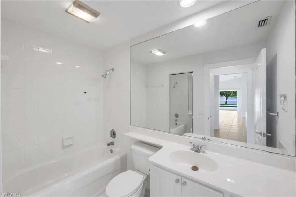 3748 Exuma Way Naples, FL 34119 - Photo 15 of 50 Bathroom with vanity and tub / shower combination. Linen closet.