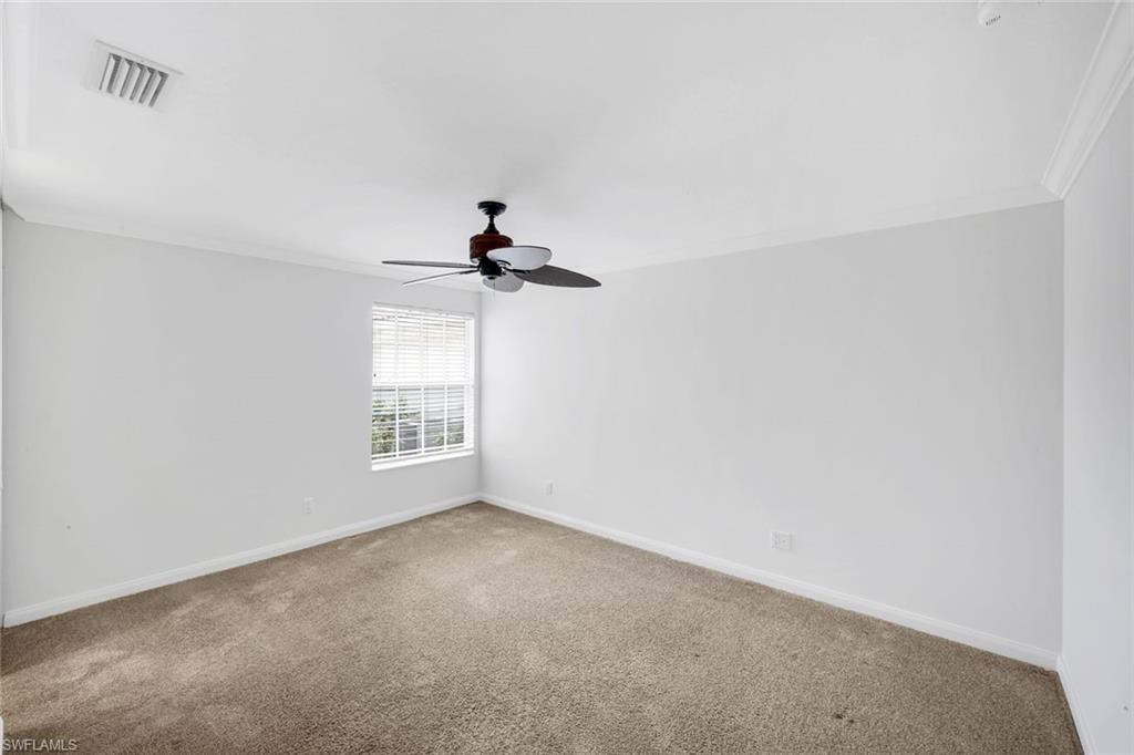 3748 Exuma Way Naples, FL 34119 - Photo 16 of 50 Carpeted guest bedroom with crown molding and a ceiling fan.