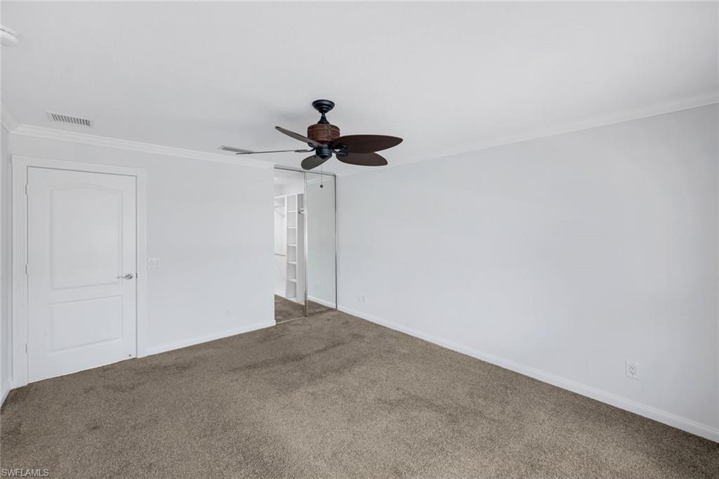 3748 Exuma Way Naples, FL 34119 - Photo 17 of 50 Carpeted guest bedroom with ornamental molding and a ceiling fan