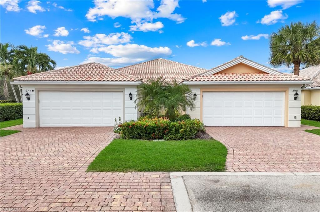3748 Exuma Way Naples, FL 34119 - Photo 3 of 50 View of front of home with a tiled roof, stucco siding, and decorative driveway