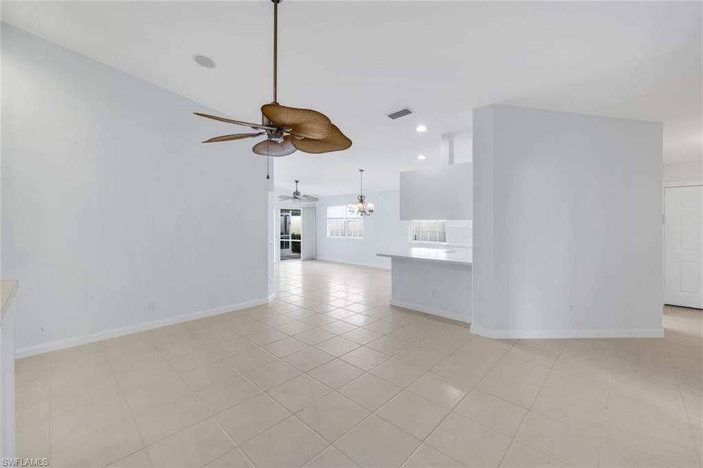 3748 Exuma Way Naples, FL 34119 - Photo 33 of 50 Den/ dinning room featuring light tile patterned floors, a chandelier, recessed lighting, and a ceiling fan