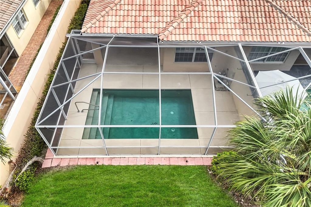 3748 Exuma Way Naples, FL 34119 - Photo 5 of 50 View of rear of property featuring a screened lanai and pool.