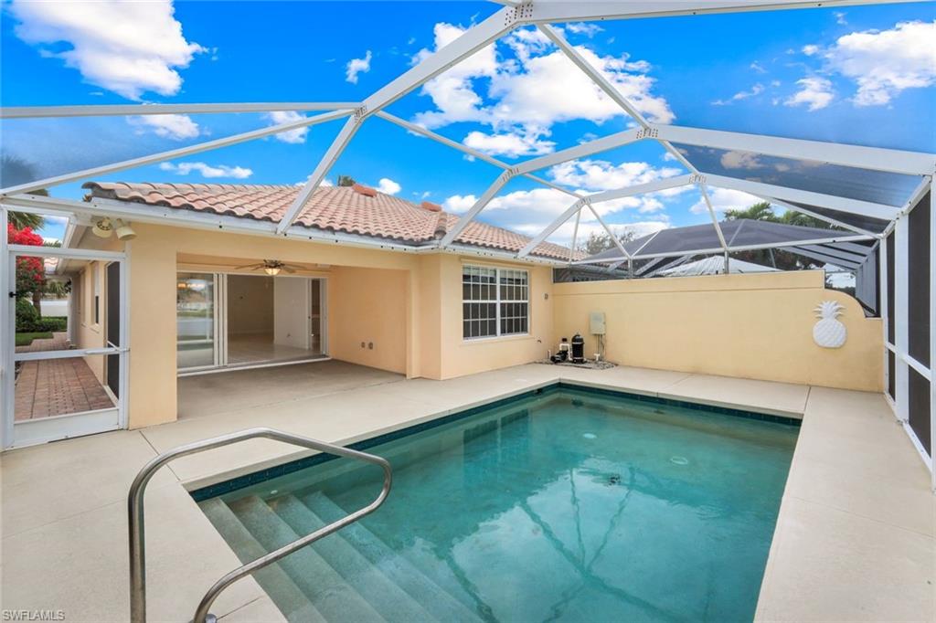 3748 Exuma Way Naples, FL 34119 - Photo 10 of 50 Outdoor pool with a sunroom, a patio area, ceiling fan, and screen enclosure.